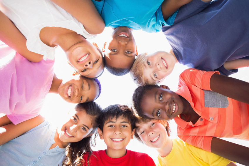 Pupils standing in a circle on a sunny day